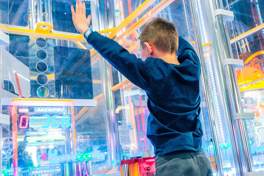 Boy Playing Big Arcade Game