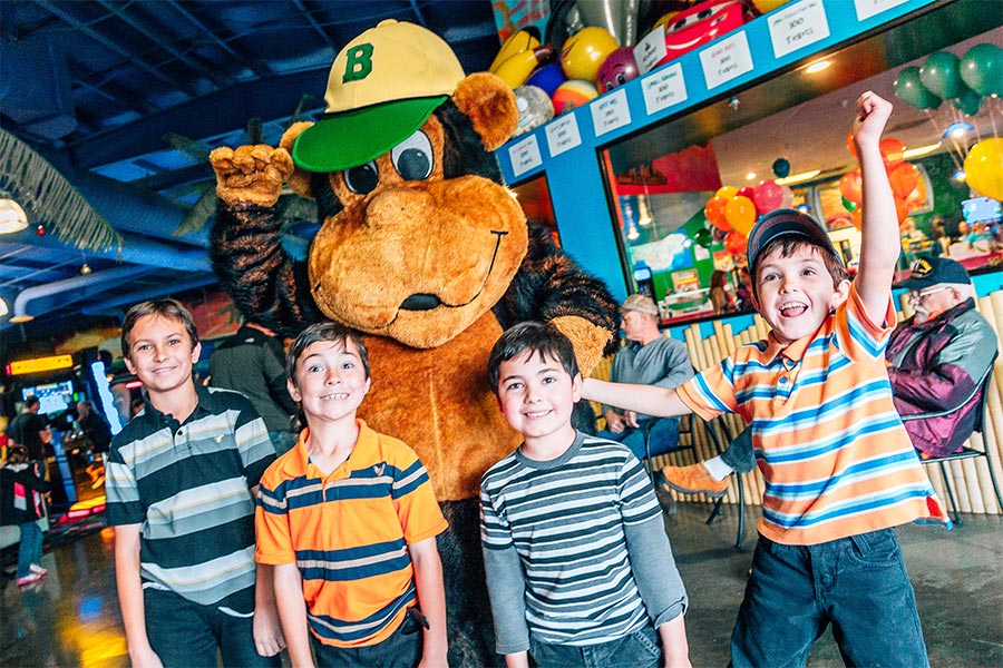 Four Boys In Arcade With Mascot