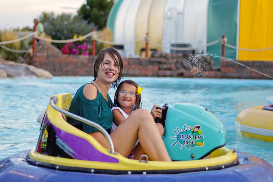Two Guests Smile On Bumper Boats