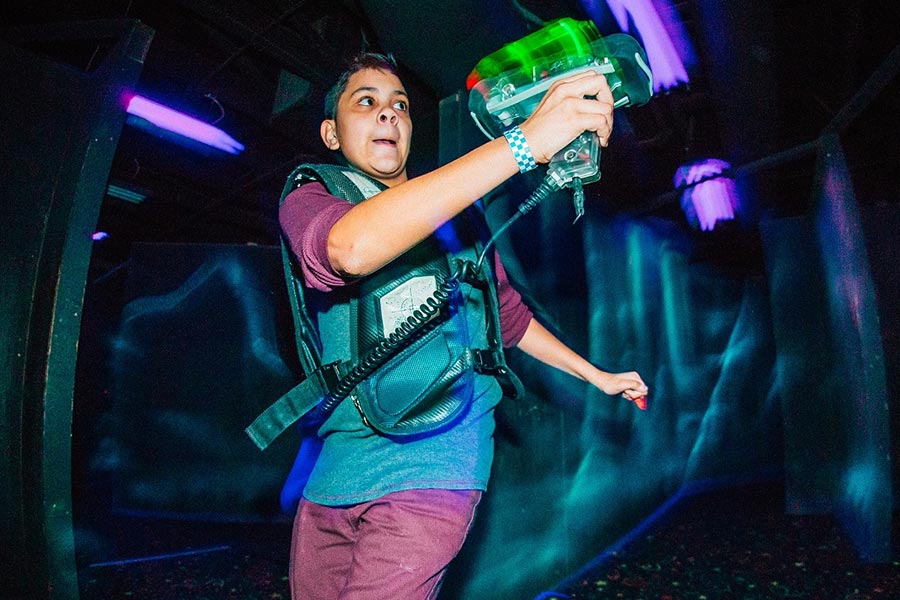 Boy Intensely Playing Lazer Tag