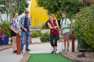 Four Guests Playing Mini Golf