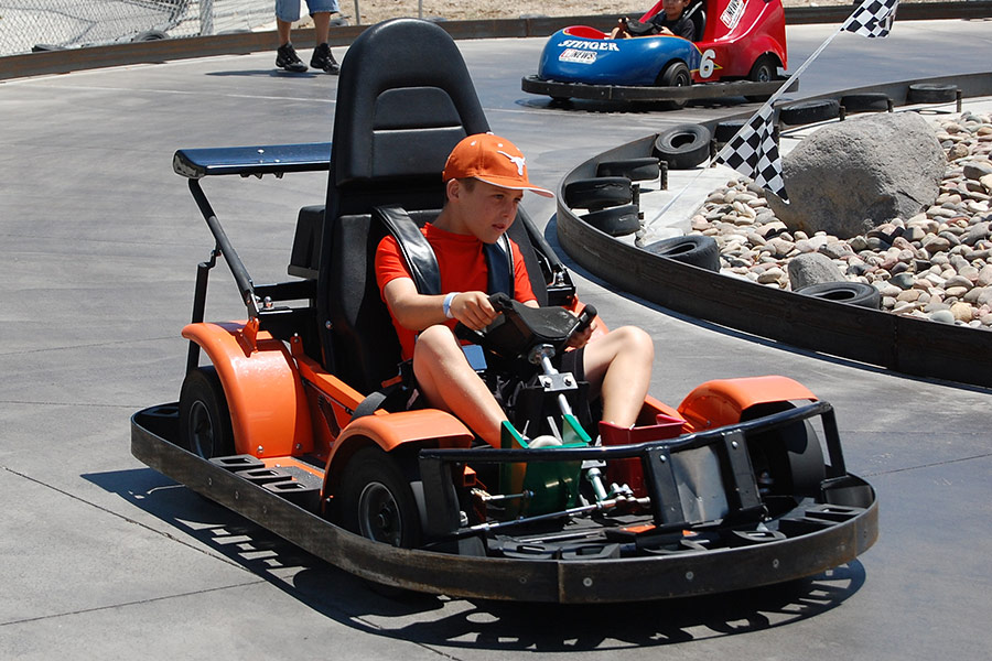 Boy Driving Orange Go Kart